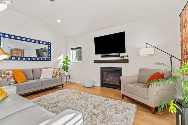 living room featuring vaulted ceiling and hardwood / wood-style floors