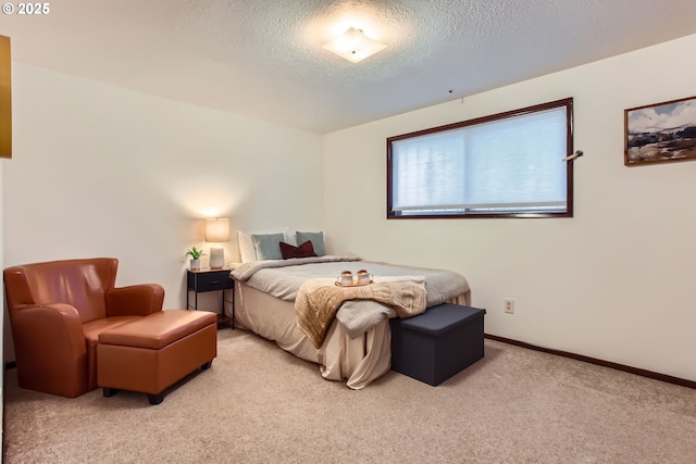bedroom with light carpet, a textured ceiling, and baseboards