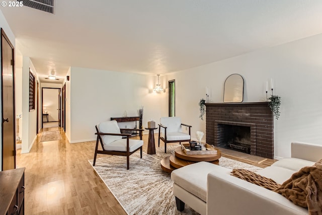 living room featuring light wood-style flooring and a fireplace