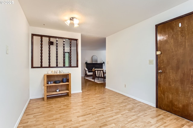unfurnished room featuring light wood-style flooring and baseboards