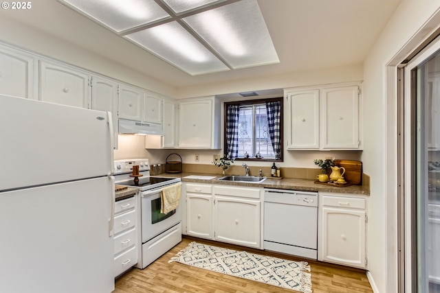 kitchen featuring white appliances, under cabinet range hood, a sink, white cabinets, and light wood-style flooring