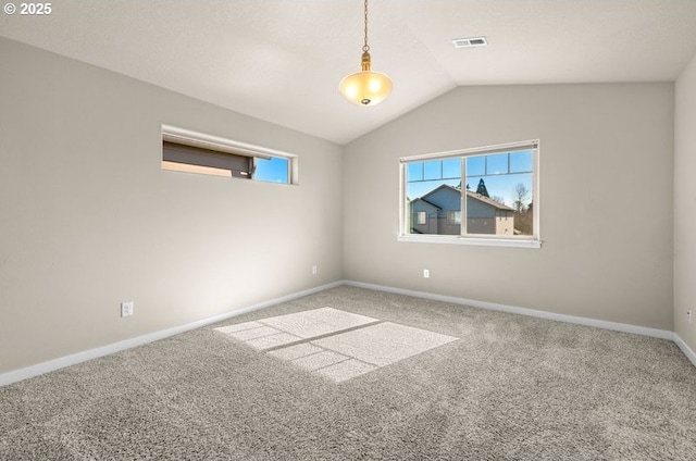 unfurnished room featuring carpet, visible vents, and a wealth of natural light