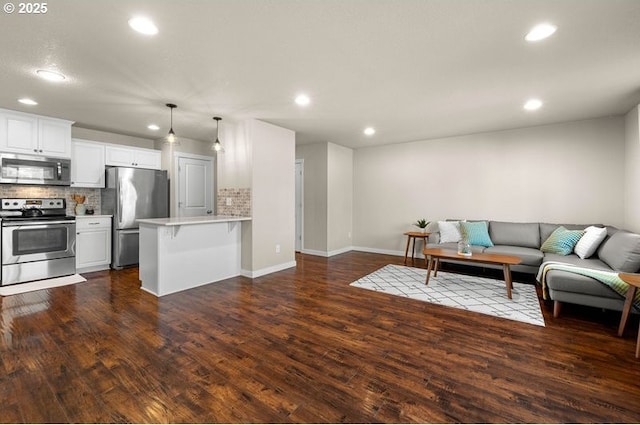 living room with dark wood-style floors, baseboards, and recessed lighting