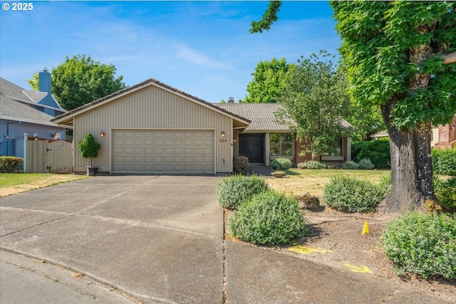 324 N Peacock Ct, Newberg, OR 97132 - ranch-style house with an attached garage, a tile roof, driveway, a gate, and a chimney