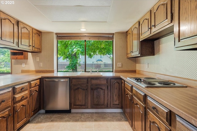 324 N Peacock Ct, Newberg, OR 97132 - kitchen featuring stainless steel dishwasher, electric cooktop, light countertops, and plenty of natural light
