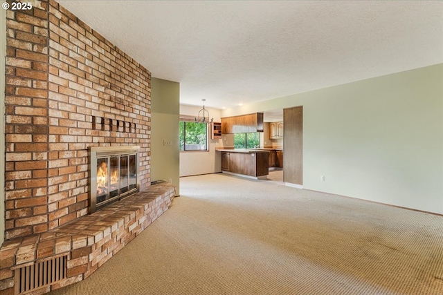 324 N Peacock Ct, Newberg, OR 97132 - unfurnished living room featuring light colored carpet, a fireplace, and a textured ceiling
