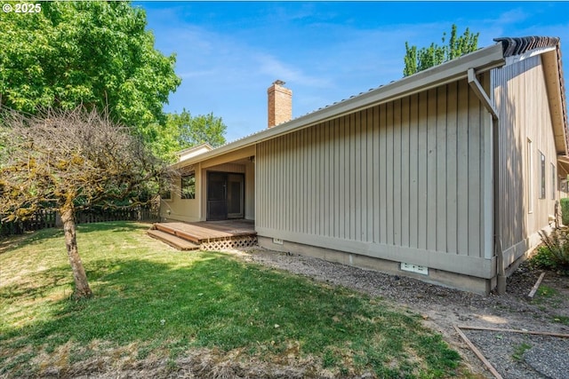 324 N Peacock Ct, Newberg, OR 97132 - view of side of property featuring a wooden deck, a chimney, and a yard