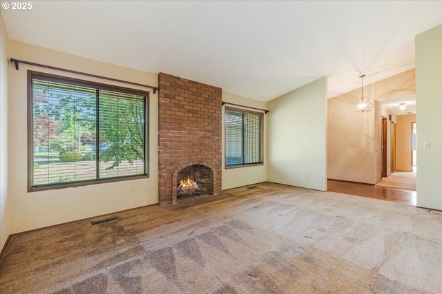 324 N Peacock Ct, Newberg, OR 97132 - unfurnished living room with carpet, lofted ceiling, and a brick fireplace