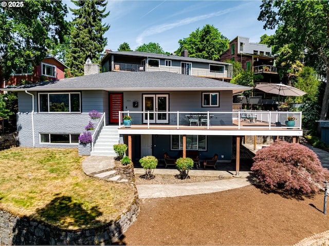 5210 N Emerson Dr, Portland, OR 97217 - view of front of property featuring stairs, a chimney, a patio area, a front lawn, and a wooden deck