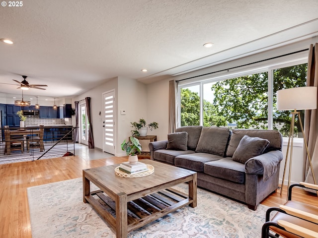 5210 N Emerson Dr, Portland, OR 97217 - living area featuring healthy amount of natural light, a textured ceiling, light wood-type flooring, recessed lighting, and ceiling fan