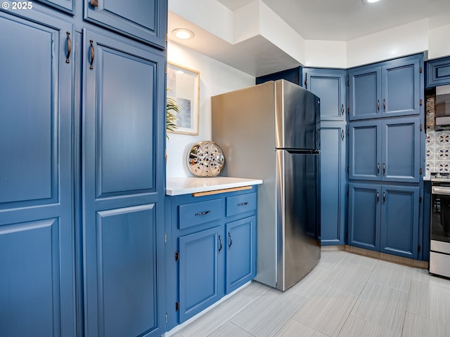 5210 N Emerson Dr, Portland, OR 97217 - kitchen with blue cabinets, appliances with stainless steel finishes, light countertops, and recessed lighting