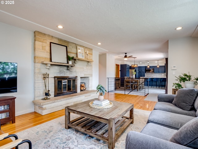5210 N Emerson Dr, Portland, OR 97217 - living room featuring light wood-style flooring, a fireplace, a ceiling fan, and recessed lighting