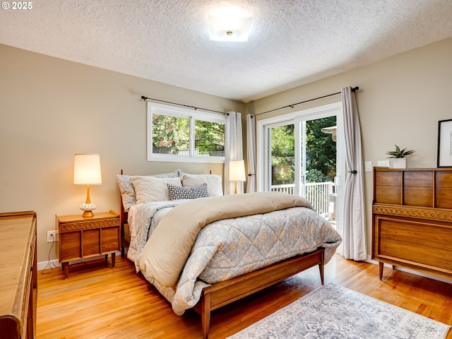 5210 N Emerson Dr, Portland, OR 97217 - bedroom with access to outside, a textured ceiling, and light wood-style floors