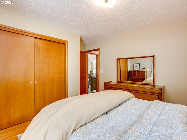 5210 N Emerson Dr, Portland, OR 97217 - bedroom featuring a closet, wood finished floors, and a textured ceiling