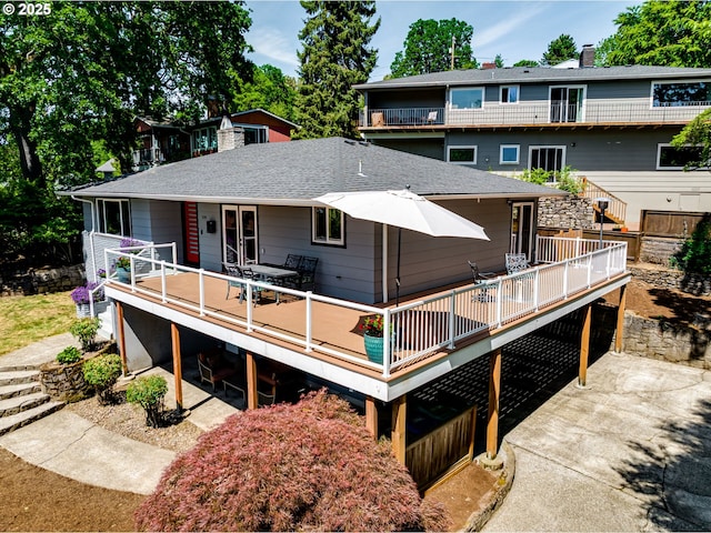 5210 N Emerson Dr, Portland, OR 97217 - back of house featuring a wooden deck, a chimney, outdoor dining space, and a shingled roof
