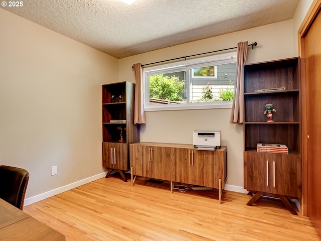 5210 N Emerson Dr, Portland, OR 97217 - office space with light wood-style flooring, a textured ceiling, and baseboards
