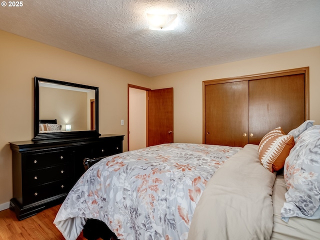 5210 N Emerson Dr, Portland, OR 97217 - bedroom with wood finished floors, a closet, and a textured ceiling