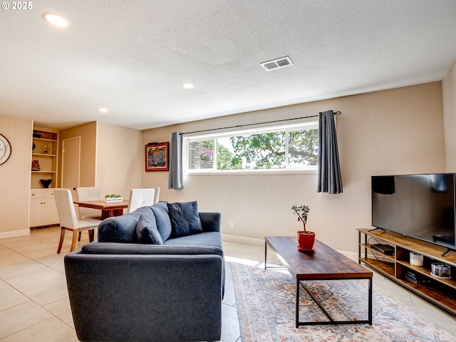 5210 N Emerson Dr, Portland, OR 97217 - living room featuring light tile patterned flooring, a textured ceiling, baseboards, and recessed lighting