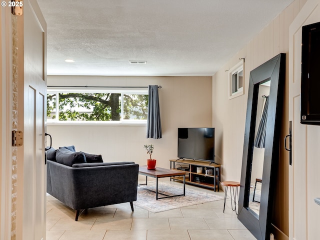 5210 N Emerson Dr, Portland, OR 97217 - living area featuring a textured ceiling and light tile patterned floors