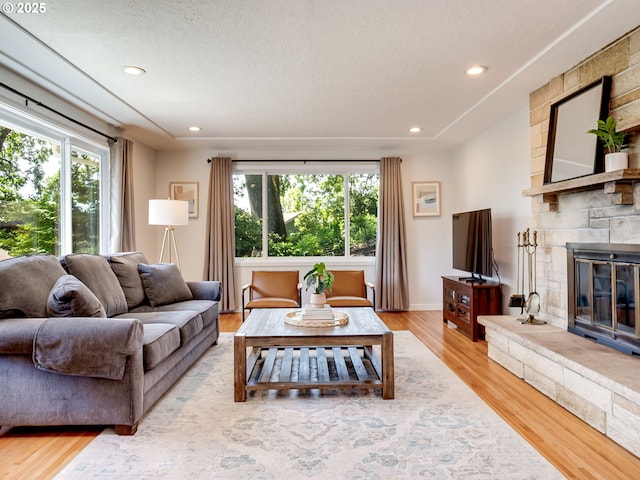 5210 N Emerson Dr, Portland, OR 97217 - living area with healthy amount of natural light, a fireplace, light wood finished floors, recessed lighting, and baseboards