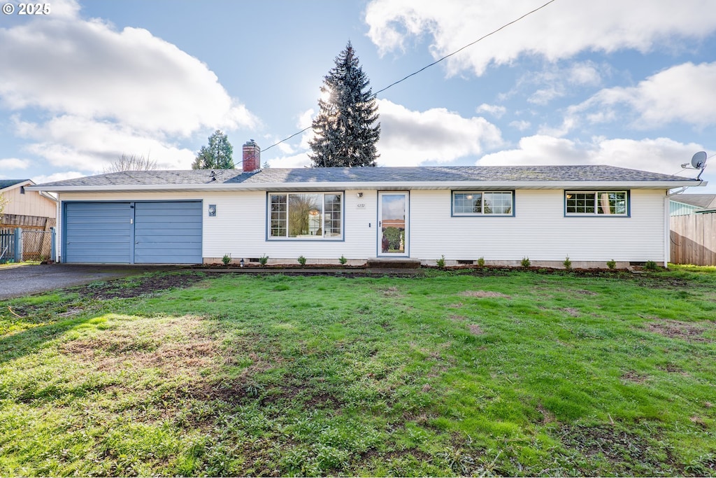 ranch-style home with a front lawn and a garage