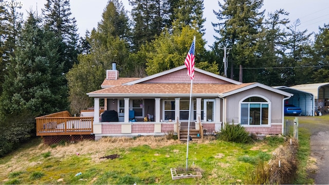 rear view of property with a carport