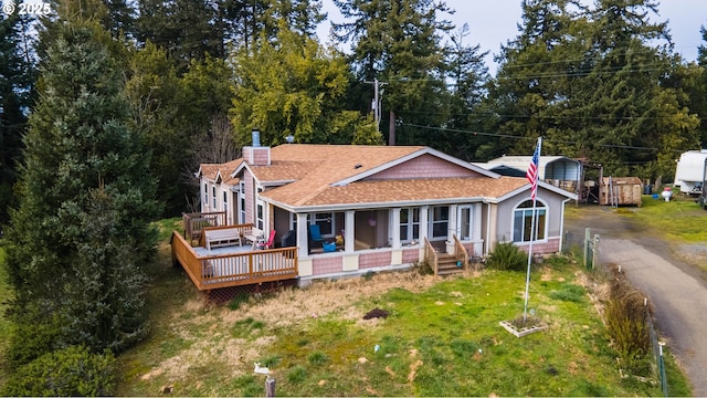 view of front of property with a porch and a front yard