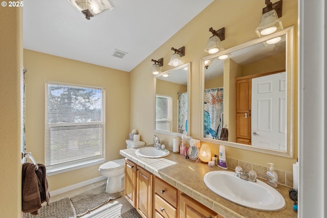 bathroom featuring tile patterned floors, vanity, and toilet