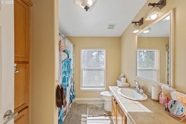 bathroom with vanity, tile patterned flooring, and toilet