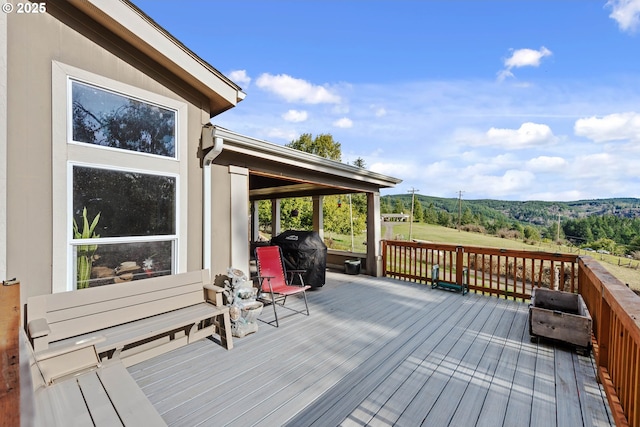 wooden terrace featuring grilling area