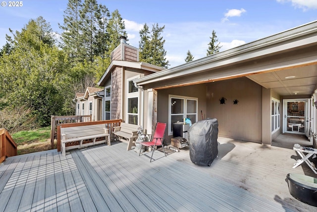 wooden terrace featuring a grill