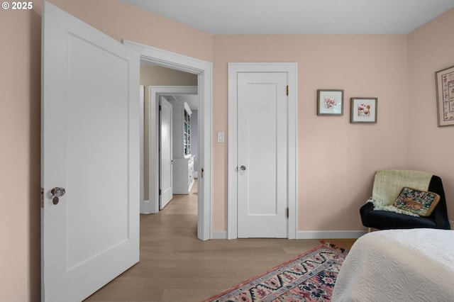 bedroom featuring baseboards and light wood-style floors