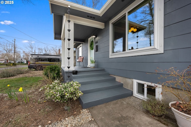 property entrance with visible vents and a porch