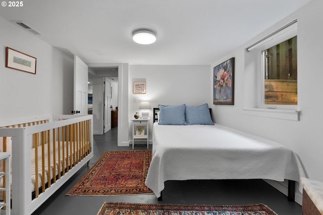 bedroom featuring visible vents and concrete flooring