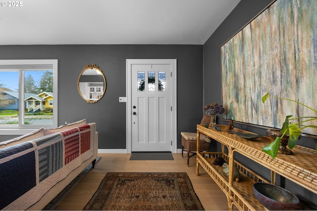 foyer with baseboards and wood finished floors