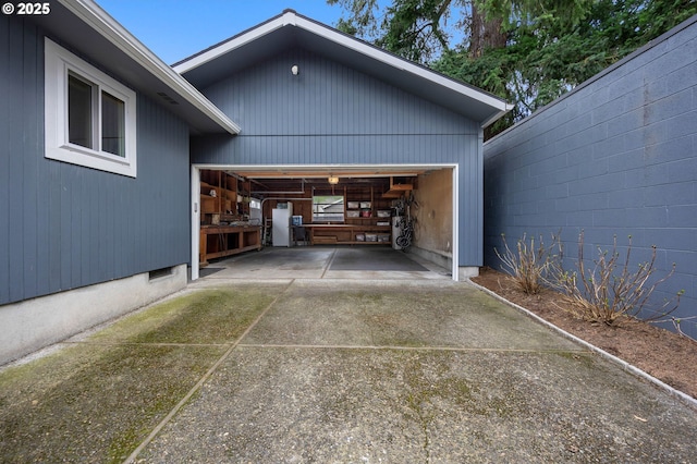 garage featuring concrete driveway