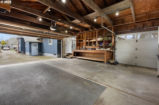 garage featuring a workshop area and a garage door opener