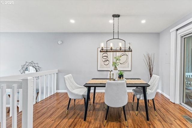 dining area with wood finished floors, an inviting chandelier, baseboards, visible vents, and recessed lighting