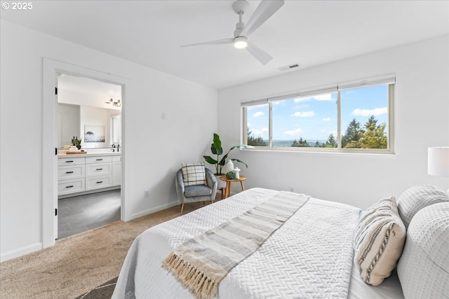 bedroom with ensuite bathroom, ceiling fan, baseboards, carpet flooring, and visible vents