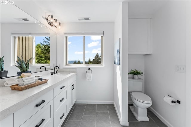 bathroom featuring baseboards, visible vents, vanity, and tile patterned floors