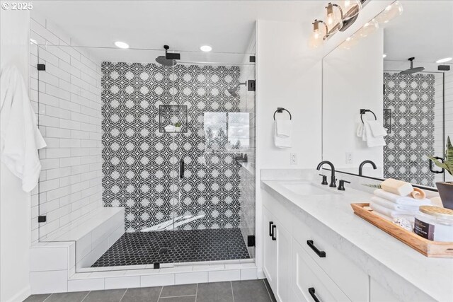 bathroom with a shower stall, vanity, tile patterned flooring, and recessed lighting