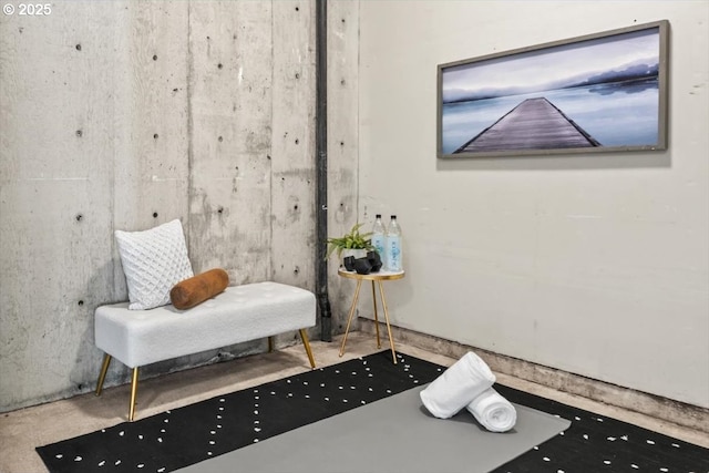 sitting room featuring concrete flooring