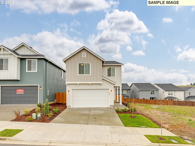 traditional-style home with board and batten siding, an attached garage, driveway, and fence