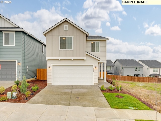 view of front of house featuring an attached garage, board and batten siding, driveway, and fence