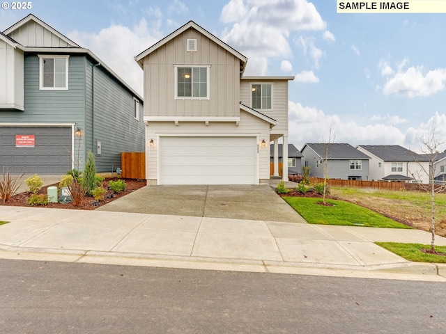 view of front of house featuring fence, an attached garage, concrete driveway, a front lawn, and board and batten siding