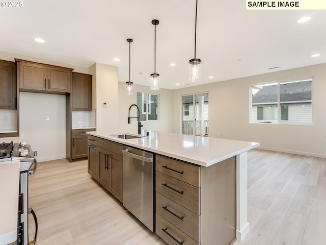 kitchen with tasteful backsplash, light wood-type flooring, appliances with stainless steel finishes, and a sink