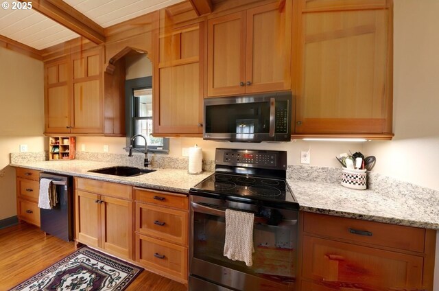 369 37th St, Astoria, OR 97103 - kitchen with open shelves, light stone countertops, wood finished floors, and arched walkways