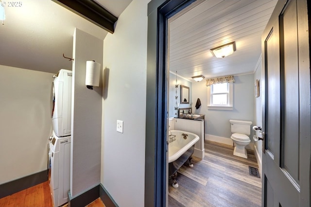 369 37th St, Astoria, OR 97103 - corridor featuring wood finished floors, crown molding, baseboards, and arched walkways