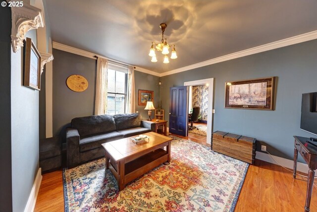 369 37th St, Astoria, OR 97103 - living room with arched walkways, wood finished floors, baseboards, decorative columns, and ornamental molding