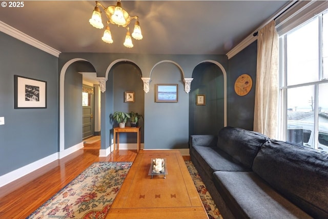 369 37th St, Astoria, OR 97103 - sitting room featuring arched walkways, a chandelier, wood finished floors, baseboards, and crown molding